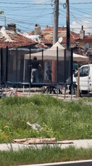 Woman and child bounce on residential trampoline in Burgas