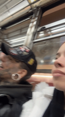 Costumed dancer and tattooed passenger ride Buenos Aires transit