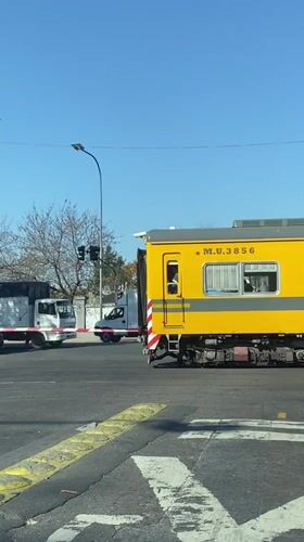 Línea Urquiza train crosses Buenos Aires road intersection