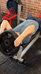 Man performs unconventional forehead weight exercise in Saint Petersburg gym