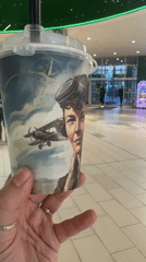 Person holds artistic beverage cup in Minsk building