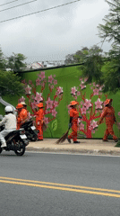 Sanitation workers take break on Da Lat sidewalk