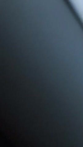 The video shows a blurry view of nature. The first few seconds appear to be a close-up of a plant with green and white leaves. The camera then pans up to reveal a pale blue sky with wispy clouds. A dark silhouette of trees or hills is visible at the bottom of the frame. The video concludes with a view of silhouetted trees against a sky that is beginning to show warmer tones, suggesting either sunrise or sunset. There are no people or discernible actions taking place.