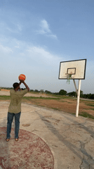 Men play basketball on outdoor court in Akwanga, Nigeria