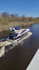 Motor yacht navigates Moscow-area waterway near Орево district