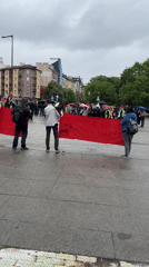 Group holds red banner in rainy Sofia square