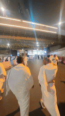 Pilgrims moving through Makkah streets at night