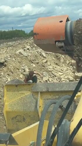 Worker searches rock pile at Bulgarian construction site