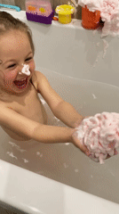 Young girl enjoys bath time and fountain play in Zelenogradsk