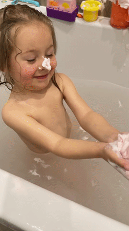 Young girl enjoys bath time and fountain play in Zelenogradsk