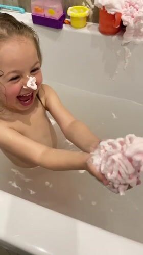 Young girl enjoys bath time and fountain play in Zelenogradsk