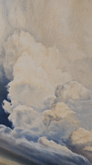 Landscape painting with white clouds observed on wall