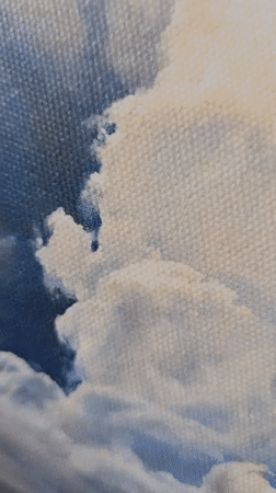 Landscape painting with white clouds observed on wall