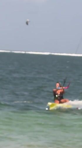 Kitesurfers catch air off the Denpasar coast on a clear morning