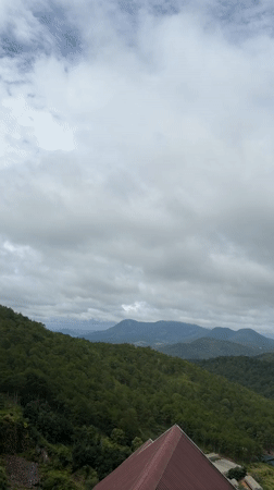 Xuân Thành valley and forested hills on a cloudy morning
