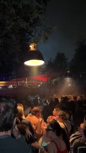 Large nighttime outdoor party observed in Copenhagen with DJ stage