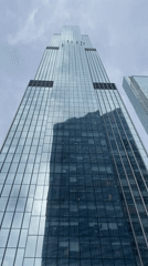 Window washers work on Khimki skyscraper under cloudy skies