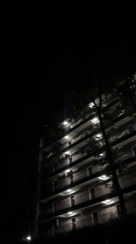 Nighttime moon and residential buildings observed in Yuzhong District