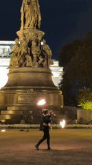 Fire poi performance in front of a classical monument, St. Petersburg