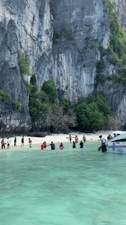 Morning beach activities captured at Ao Nang's limestone cliffs