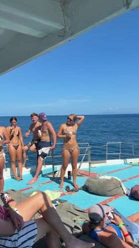 Young adults enjoy boat day near Ko Tao Thailand