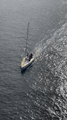 Sailboat cruising the Gulf of Finland under patchy summer skies