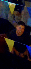 Man works on technical device during festive gathering in Arica