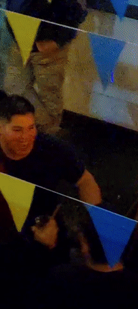 Man works on technical device during festive gathering in Arica