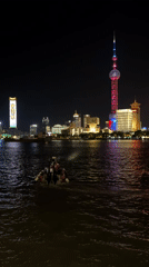 Evening crowds gather along Shanghai's illuminated waterfront district
