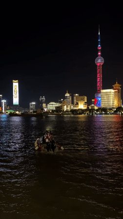 Evening crowds gather along Shanghai's illuminated waterfront district