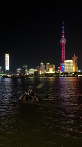 Evening crowds gather along Shanghai's illuminated waterfront district