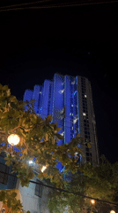 Blue neon-lit building observed at night in Vietnam