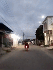 Dusk ride through Lhokseumawe streets, brake lights ahead