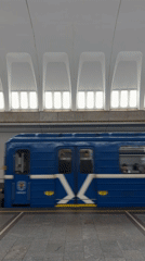 Blue subway train 1497 carries passengers through Minsk station