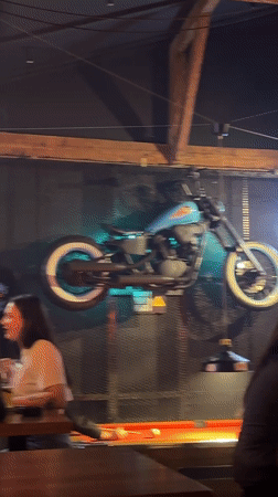 Belgrade bar features motorcycle wall decor, foreign currency display