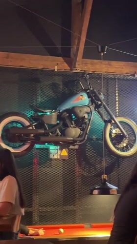 Belgrade bar features motorcycle wall decor, foreign currency display