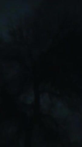 The video shows a dark and blurry scene. The camera moves slightly, shifting focus and revealing hints of texture and depth, but no distinct objects or people are visible. The overall impression is one of darkness and obscurity.