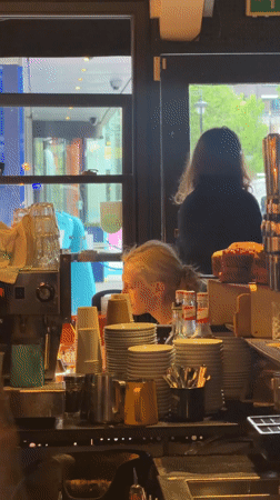 Service worker tends counter with dishes in London