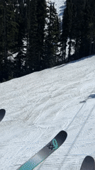 Skier rides evening lift at Whistler mountain resort