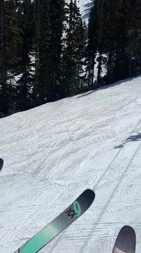 Skier rides evening lift at Whistler mountain resort