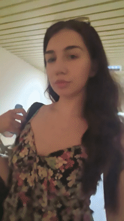 Woman in floral dress moves through Bulgarian educational facility