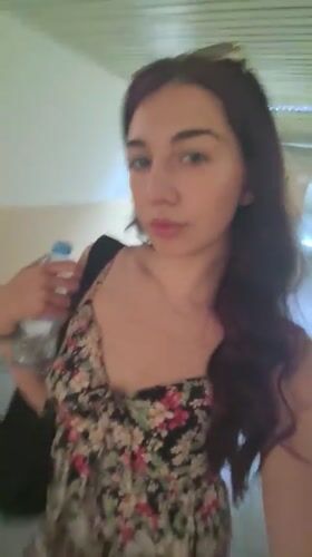 Woman in floral dress moves through Bulgarian educational facility