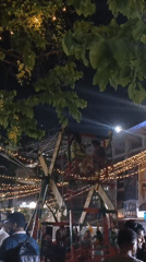 Evening market gathering illuminated by festive lights in Dhaka