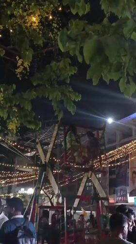Evening market gathering illuminated by festive lights in Dhaka