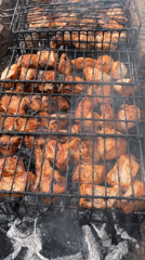 Woman grills meat outdoors in rural Russian village