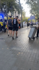 Skateboarders, an ambulance, and a Barcelona plaza evening