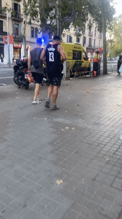 Skateboarders, an ambulance, and a Barcelona plaza evening