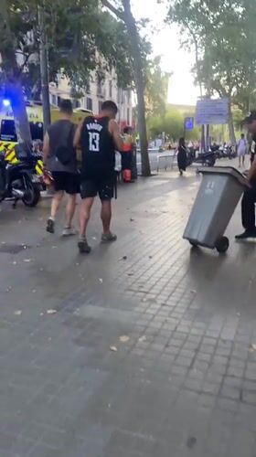 Skateboarders, an ambulance, and a Barcelona plaza evening