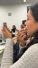 Woman applies makeup in Mexico City office late night