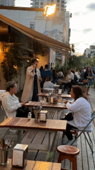 Evening cafe scene with diners and cyclists in Tel-Aviv